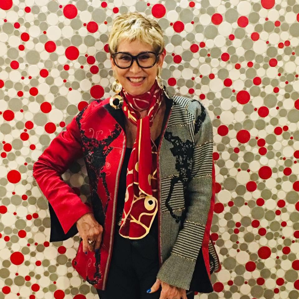 Bonnie Roseman in a mixed-pattern jacket with a red silk scarf